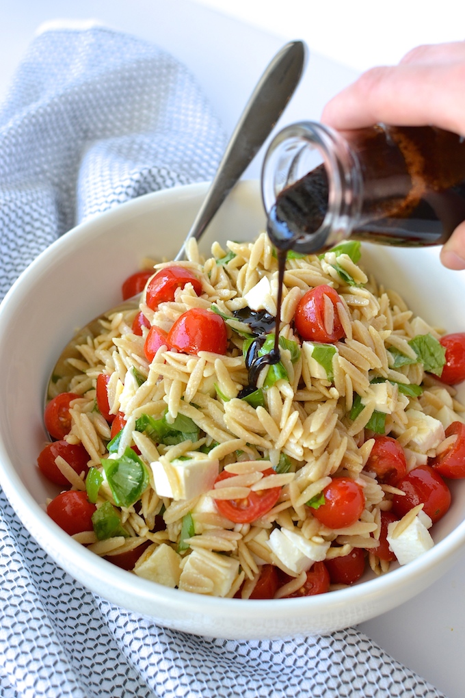 Caprese Orzo Salad with Balsamic Syrup - Fresh mozzarella, juicy tomatoes, garden basil and orzo pasta drizzled with a sweet balsamic syrup...perfect for a weekday lunch or as a side at your summer BBQ! ~sweetpeasandabcs.com