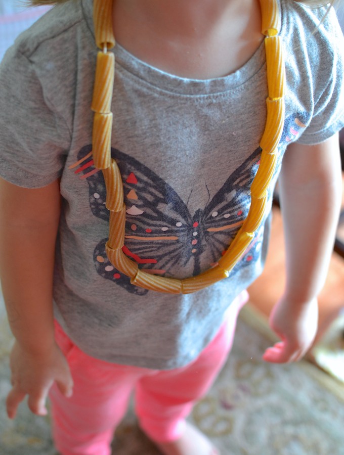 Threading with Noodles - Use pasta noodles like beads for threading in this activity to help strengthen children's fine motor skills! ~sweetpeasandabcs.com